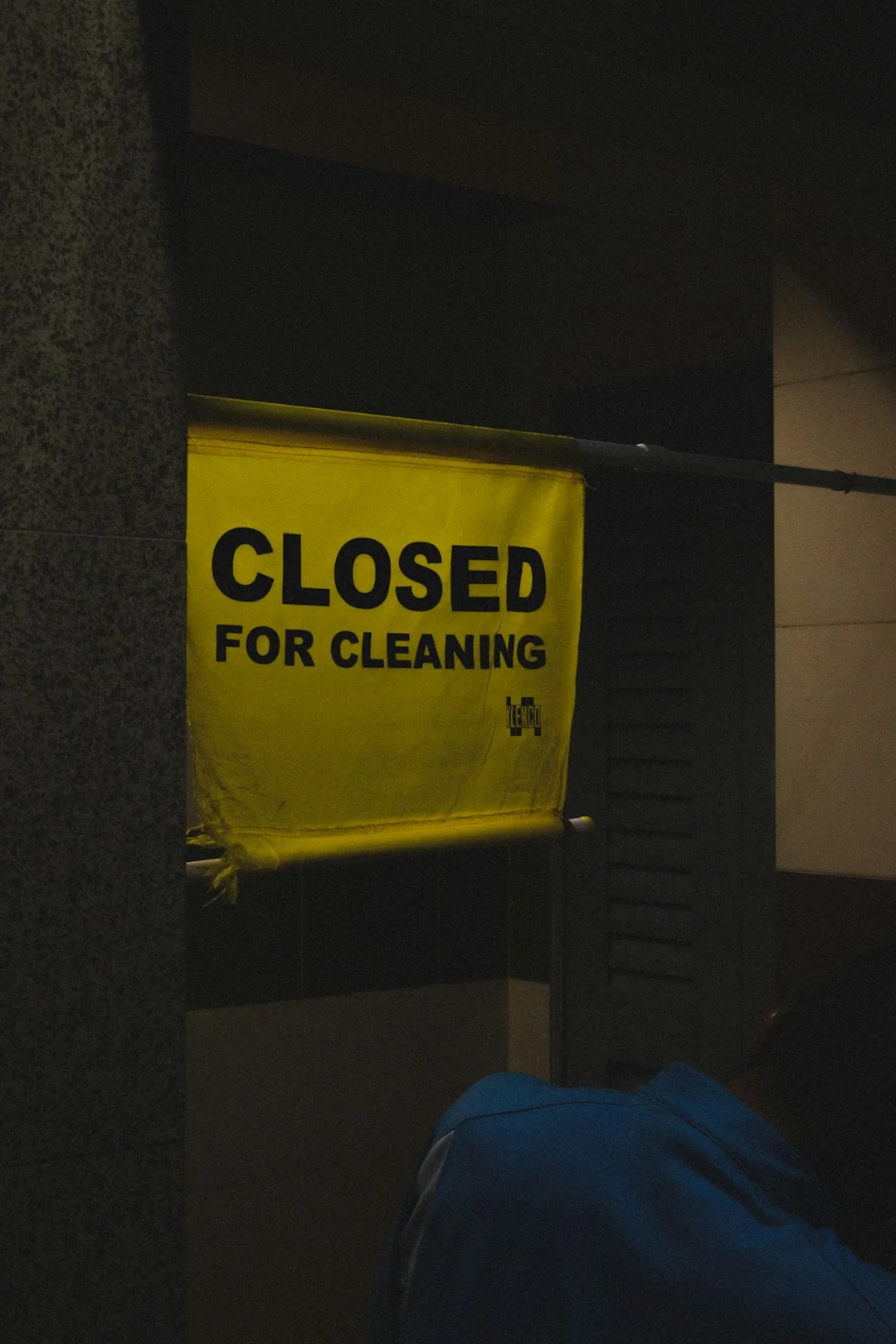 Cleaner using a vacuum in a stylish indoor setting, showcasing cleaning equipment and techniques.
